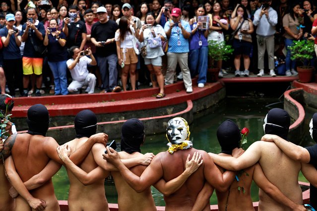 Naked student fraternity members present themselves to a crowd during their Oblation Run at the University of the Philippines in Quezon City, Metro Manila, Philippines, 14 February 2025. The naked run, known as the Oblation Run, attempts to bring attention to current issues of importance in Philippine society. This year, naked runners carried signs with messages to vote wisely in the upcoming May 2025 elections, impeach Vice-President Sara Duterte, and to criticize Senator Imee Marcos. (Photo by Rolex dela Peña/EPA/EFE)