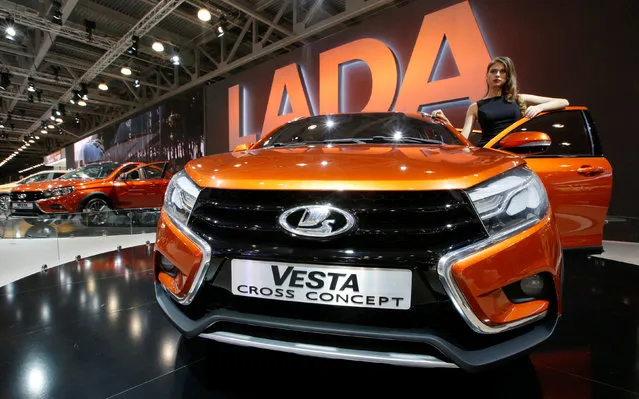 A model poses beside a Lada Vesta Cross Concept car on display at the 2016 Moscow International Auto Salon in Moscow, Russia, August 26, 2016. (Photo by Sergei Karpukhin/Reuters)