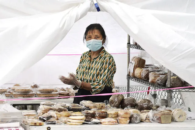 A woman sells bread and pastries at the Parkchester outdoor market in the Bronx on July 10, 2020. (Photo by Matthew McDermott/The New York Post)
