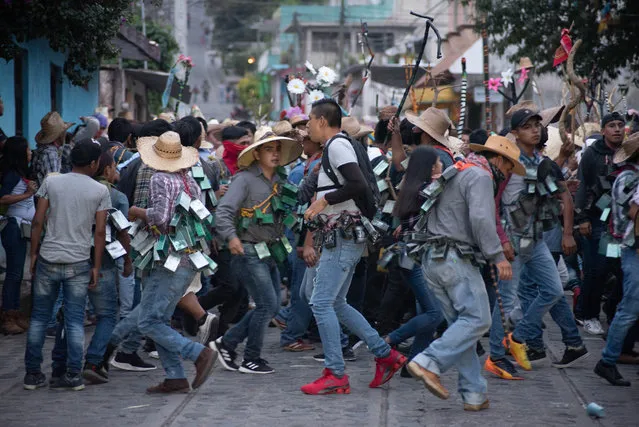 Inhabitants of the small city of Xico, in Veracruz, Mexico, celebrate Santa Maria Magdalena with “The night of the cowbells”, where thousands of people take to the streets dancing with cowbells to honor Santa Maria Magdalena on July 11, 2020. This party was held to ask for protection against COVI-19, however the population is now vulnerable to more infections. (Photo by Hector Adolfo Quintanar Perez/ZUMA Wire/Rex Features/Shutterstock)