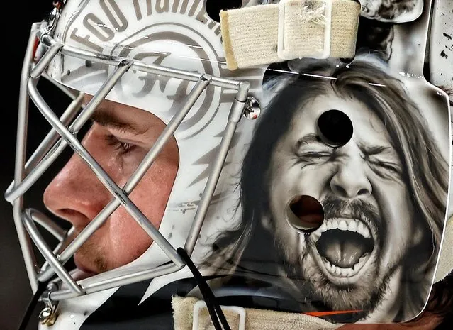 Wearing a Foo Fighters mask, Philadelphia Flyers goaltender Carter Hart heads back to his net after giving up a goal to the Boston Bruins during the third period at TD Garden, in Boston, Massachusetts on Thursday, November 17, 2022. (Photo by Winslow Townson/USA TODAY Sports)