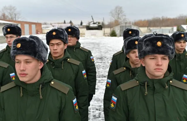 Russian conscripts called up for military service during the annual autumn draft line up at a gathering point before their departure for garrisons, in Omsk, Russia on November 10, 2022. (Photo by Alexey Malgavko/Reuters)