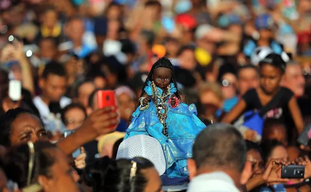 Cubans take part in the procession of the Virgen de Regla in La Regla, Havana, Cuba, 07 September 2016. The procession is held to honor the Black Madonna, or Black Virgin, a statue of the Virgin Mary depicted with black skin. (Photo by Alejandro Ernesto/EPA)