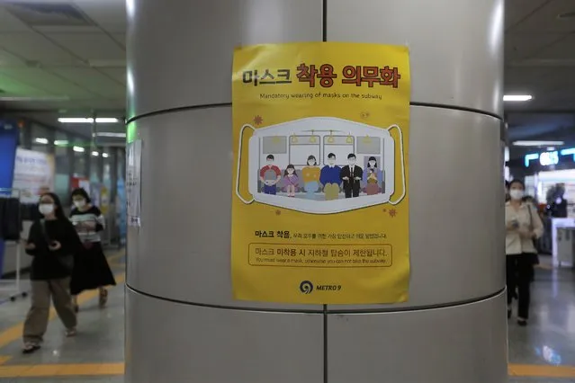 A poster on precautions against the coronavirus is displayed at a subway station in Seoul, South Korea, Wednesday, August 12, 2020. Health authorities scramble to stem transmissions amid increased social and leisure activities. (Photo by Ahn Young-joon/AP Photo)