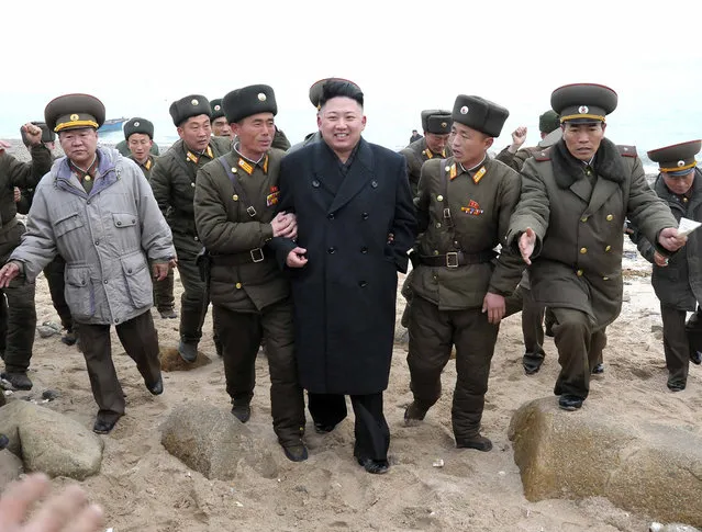 North Korean soldiers greet the North's leader Kim Jong Un during his visit to the Jangjae Islet Defence Detachment and Mu Islet Hero Defence Detachment, southwest of Pyongyang, on March 7, 2013. (Photo by Reuters/KCNA)