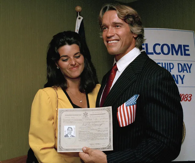 Actor and bodybuilder Arnold Schwarzenegger shows off his new U.S. citizenship papers as Maria Shriver, daughter of Sargent and Eunice Shriver, looks on, September 16, 1983, at the Shrine Auditorium in Hollywood. (Photo by Wally Fong/AP Photo)