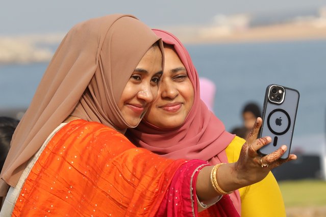 Sri Lankan Muslims pose for photos following Eid al-Fitr prayers at the Galle Face seafront in Colombo, Sri Lanka, 31 March 2025. Muslims around the world celebrate Eid al-Fitr, a two- to three-day festival marking the end of the holy fasting month of Ramadan. (Photo by Chamila Karunarathne/EPA/EFE)