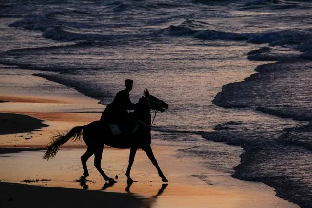 A Palestinian man rides his horse next to the beach during sunset, in the west of Gaza City, 17 February 2023. (Photo by Mohammed Saber/EPA)