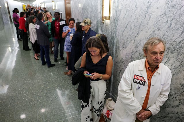 Dr. Troy Jacobs, a Washington-area pediatrician, wears a lab coat with a ''FIRE RFK'' sticker as he is among the first in line to be in the public gallery to watch a Senate Finance Committee hearing on President Trump's 2026 health care agenda, on Capitol Hill in Washington on September 4, 2025. (Photo by Jonathan Ernst/Reuters)