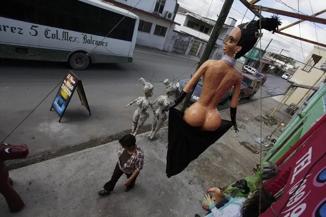 A pinata depicting TV celebrity Kim Kardashian hangs outside a workshop in Reynosa December 4, 2014. (Photo by Daniel Becerril/Reuters)