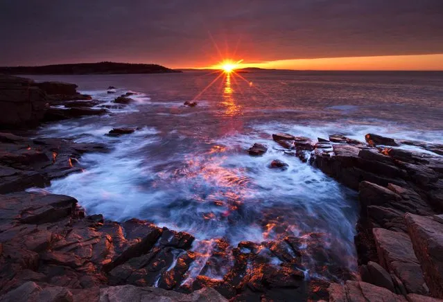 The sun's rays strike the rocky coast of Acadia National Park, in Maine, on May 2, 2013. A federal budget-related delay has pushed back the opening of many of the park's seasonal facilities until May 17. Acadia saw a 5 percent funding cut of it's roughly $7.8 million budget on March 1. The cut represented the National Park Service's share of federal sequestration. (Photo by Robert F. Bukaty/Associated Press)