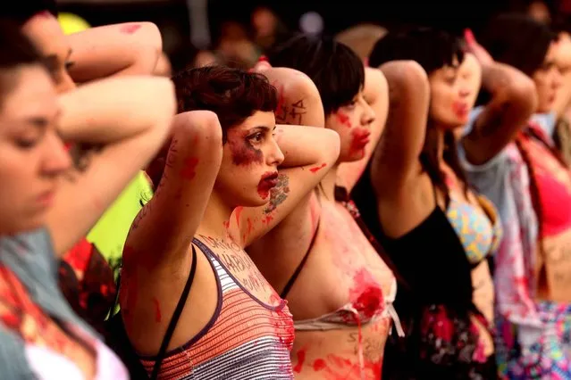 Women take part in a march in Santiago on October 19, 2016, to protest against violence against women and in solidarity for the brutal killing of a 16- year- old girl in Mar del Plata, Argentina last week The killing, in which the high school student was allegedly raped and impaled on a spike by drug dealers, is just the latest incident of horrific gender violence in Argentina, which has seen more than a year of mass marches to protest brutality against women. (Photo by Claudio Reyes/AFP Photo)