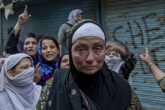 Tears roll down the cheek of Abida Malik, sister of Jammu Kashmir Liberation Front Chairman Yasin Malik, during a protest in Srinagar, Indian controlled Kashmir, Saturday, October 22, 2016. Indian police fired tear gas to disperse dozens of Kashmiri protesters protesting against the alleged denial of medical treatment to Malik, who has been in prison for the last three months. They were also demanding his immediate release. (Photo by Dar Yasin/AP Photo)
