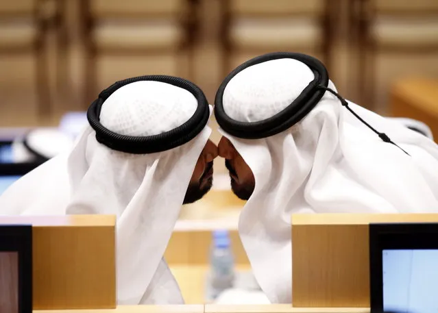 Two new members of the UAE Federal National Council (FNC) greet each other by the UAE traditional kissing during the inaugural session of the new FNC, in Abu Dhabi, United Arab Emirates, November 18, 2015. (Photo by Ali Haider/EPA)