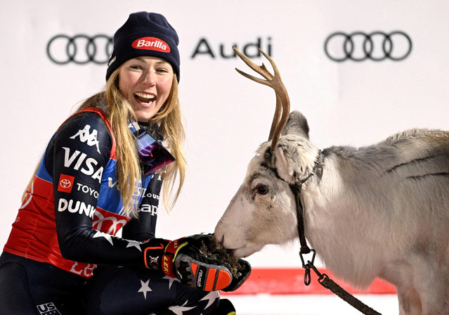 United States' Mikaela Shiffrin feeds a deer on the podium after winning an alpine ski, women's World Cup slalom, in Levi, Finland, Saturday, November 15, 2025. Photo by Roni Rekomaa/Lehtikuva via Reuters)