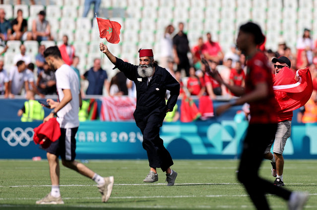 A pitch invader are seen on the pitch after the Men's group B match between Argentina and Morocco during the Olympic Games Paris 2024 at Stade Geoffroy-Guichard on July 24, 2024 in Saint-Etienne, France. (Photo by Thaier Al-Sudani/Reuters)