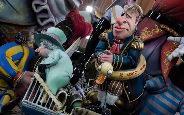 Figurines depicting political leaders are pictured during the Fallas festival in Valencia, on March 16, 2022. The fallas, gigantic cardboard structures that portray current events and celebrities in which individual figures or ninots are placed, are burned in the streets of Valencia on March 19 as a tribute to San Jose (Saint Joseph), patron saint of the carpenters' guild. (Photo by Jose Jordan/AFP Photo)