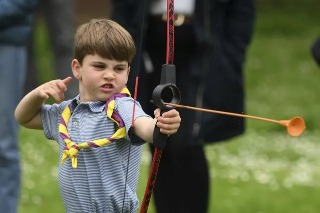Britain's Prince Louis tries his hand at archery while taking part in the Big Help Out, during a visit to the 3rd Upton Scouts Hut in Slough, England, Monday, May 8, 2023. People across Britain were on Monday asked to do their duty as the celebrations for King Charles III's coronation drew to a close with a massive volunteering drive. (Photo by Daniel Leal/Pool Photo via AP Photo)