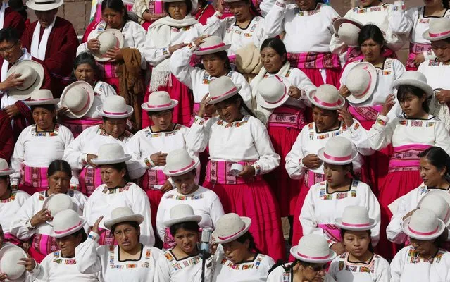 Supporters of Bolivia's President Evo Morales wait for the start of a ceremonial swearing-in, led by Aymaran spiritual guides at the archeological site Tiwanaku, Bolivia, Wednesday, January 21, 2015. (Photo by Juan Karita/AP Photo)