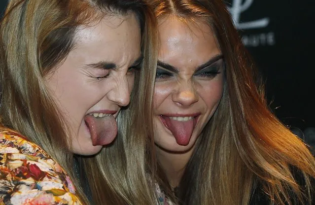 Model Cara Delevingne (R) poses for a selfie with a fan during a photo call at Selfridges department store in London January 20, 2015. (Photo by Suzanne Plunkett/Reuters)