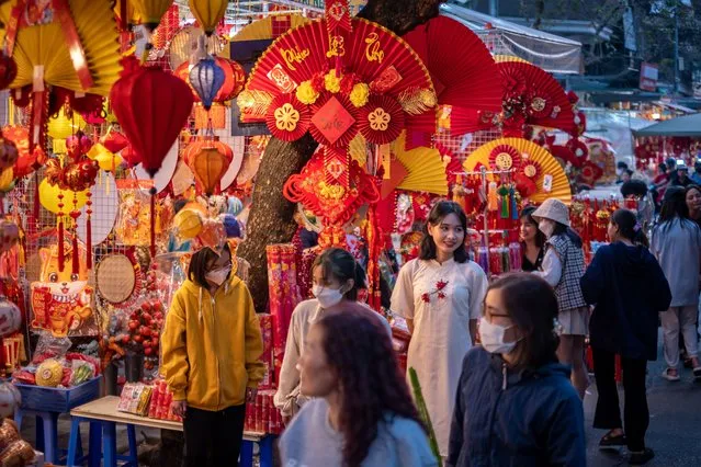 People shop for Lunar New Year decoration items at the Spring Festival Fair in the Old Quarter on January 14, 2023 in Hanoi, Vietnam. (Photo by Linh Pham/Getty Images)