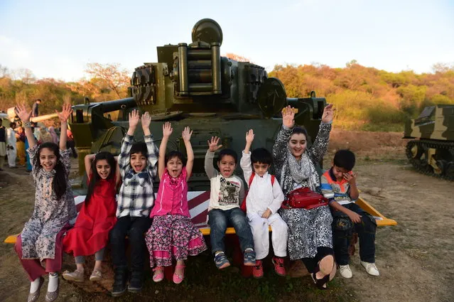 Pakistani children sit on a tank as they enjoy the park during a public holiday ahead of National Day celebration in Rawalpindi on March 22, 2015. (Photo by Farooq Naeem/AFP Photo)
