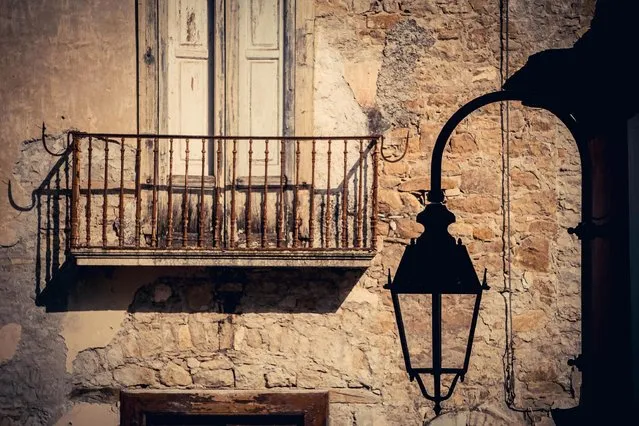 A rusted balcony hangs on the wall of a building in the ghost town of Apice, in the province of Benevento, southern Italy, 22 November 2016. (Photo by Cesare Abbate/EPA)