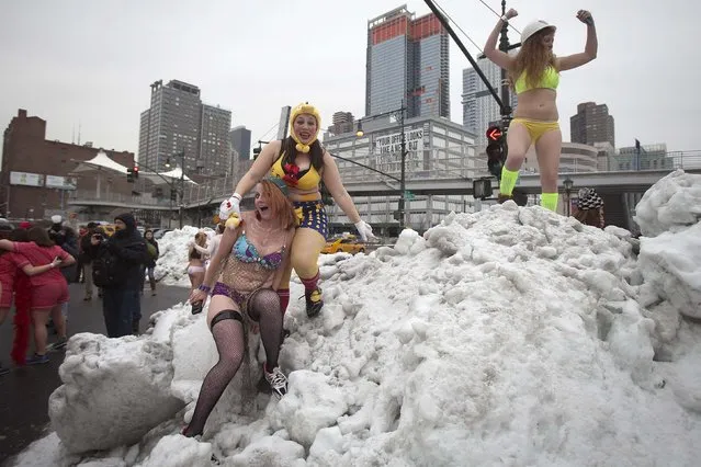 People climb on snow banks after taking part in the Cupid's Undie Run in the Manhattan borough of New York February 7, 2015. (Photo by Carlo Allegri/Reuters)