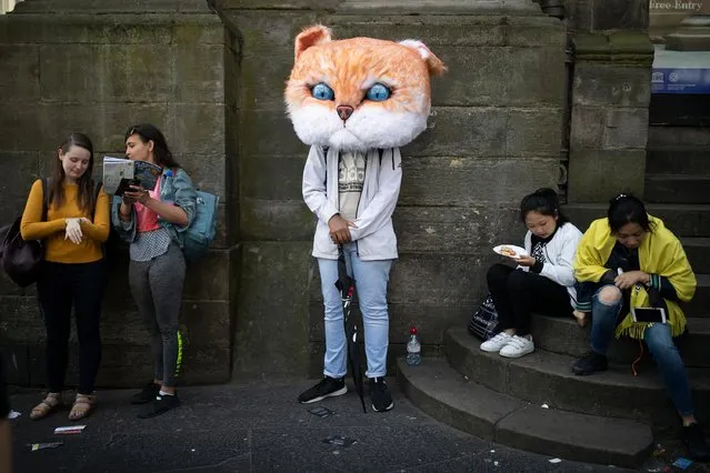 A performer takes a rest from promoting his show on the Royal Mile during the Edinburgh Fringe on August 3, 2018 in Edinburgh, Scotland. (Photo by James Glossop/The Times)