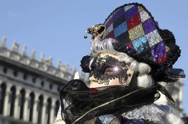 A masked reveller poses at Saint Mark's square during Carnival in Venice, February 8, 2015. The carnival runs until February 17. (Photo by Stefano Rellandini/Reuters)