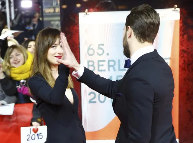 Actors Dakota Johnson and Jamie Dornan (R)  arrive for the screening of the movie “Fifty Shades of Grey” at the 65th Berlinale International Film Festival in Berlin February 11, 2015. (Photo by Hannibal Hanschke/Reuters)