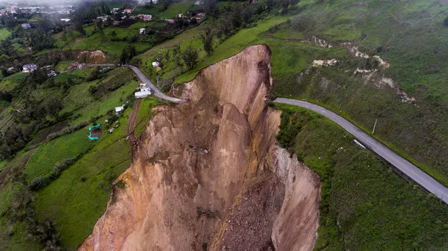 An aerial photo shows the damage left by the landslide in Chunchi, Chimborazo province, Ecuador, 15 February 2021. Chunchi, an Andean town located in the Ecuadorian province of Chimborazo, remains vigilant after a mountain collapsed on 12 February in the neighboring La Armenia village, burying houses and animals. There was no human victims. (Photo by Jose Jacome/EPA/EFE)