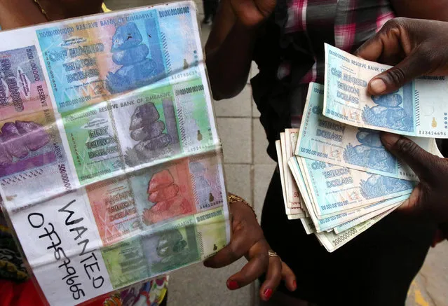An illegal foreign currency trader counts notes at a local bus station in the capital Harare, Zimbabwe, November 18, 2016. (Photo by Philimon Bulawayo/Reuters)
