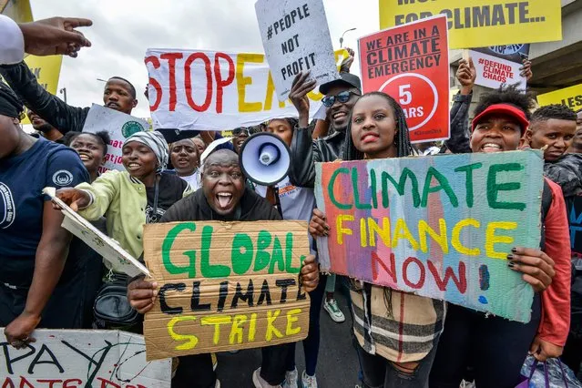 Climate activists hold placards and chant slogans as they take part in a march in Nairobi on September 4, 2023. The activists from various nationalities urged delegates attending the Africa Climate Summit in Nairobi to engage actively in discussions to expedite the phase-out of fossil fuels. (Photo by Suleiman Mbatiah/AFP Photo)