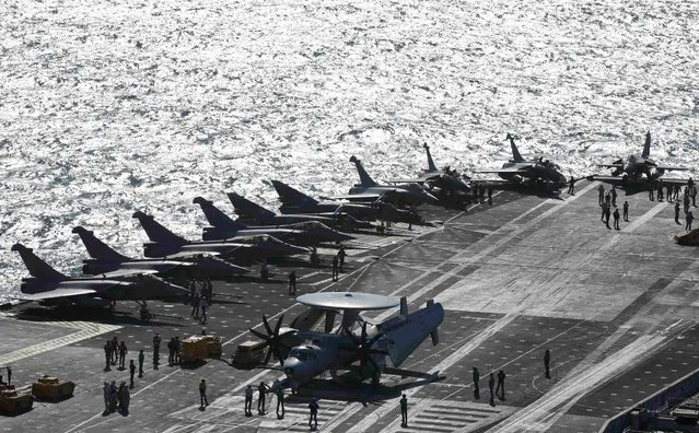 Rafale fighter jets, Super Etendards and a E2C Hawkye (C) are seen aboard France's Charles de Gaulle aircraft carrier that is on mission in the Gulf, January 28, 2016. (Photo by Philippe Wojazer/Reuters)