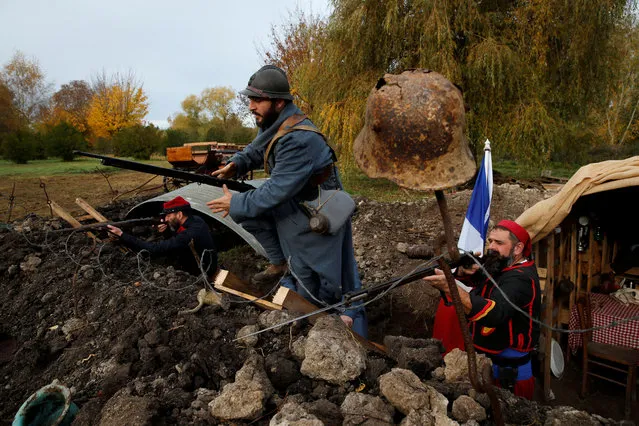 History enthusiasts, members of French association Tempus Fugit, dressed in World War One French military outfits, re-enact daily life of soldiers during trench warfare, in Ecourt-Saint-Quentin, France, November 9, 2018. (Photo by Pascal Rossignol/Reuters)