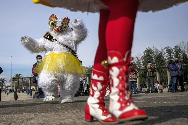“La Diablada” dancers take part in a celebration in honor of the Virgin del Carmen, patron saint of Chile, in Santiago, Chile, Saturday, July 16, 2022. Hundreds of cowboys in woolen ponchos and families on wooden horse carts lined up to receive a priest's blessing in the huge esplanade in front of the National Sanctuary of Maipu on Saturday afternoon. (Photo by Esteban Felix/AP Photo)