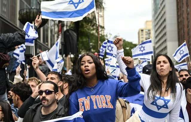 People take part in a Pro-Palestinian demonstration held in front of the Consulate General of Israel in New York City, United States on October 09, 2023. On the opposite side of the protest area, a group of pro-Israel demonstrators gathered, holding Israeli flags. Verbal exchanges and taunts occurred sporadically between the two groups. (Photo by Fatih Aktas/Anadolu Agency via Getty Images)