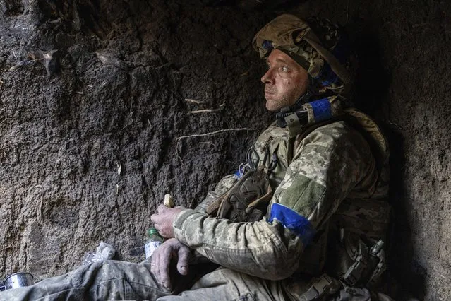 A Ukrainian serviceman from the 3rd Assault Brigade who goes by the call sign “Sheva” eats a piece of bread in a trench on his position at the frontline a few kilometers from Andriivka, Donetsk region, Ukraine, Saturday, September 16, 2023. The brigade announced Friday they had recaptured the war-ravaged settlement which is less 10 kilometers (6 miles) south of Russian-occupied city of Bakhmut, in the country's embattled east. (Photo by Alex Babenko/AP Photo).