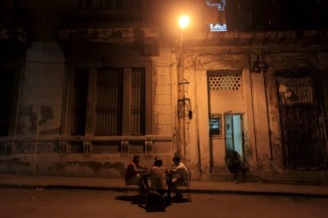 Cubans play dominoes on a street in Havana December 31, 2015. (Photo by Enrique de la Osa/Reuters)
