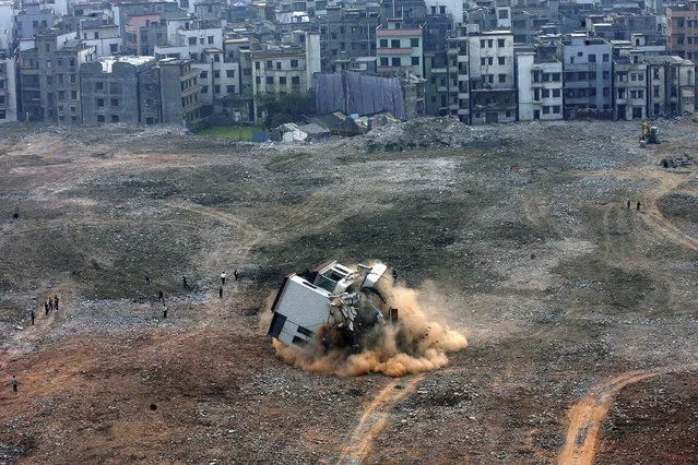 A general view shows the demolition of a “nail house”, the last house in the area, at a construction site in Guangzhou, Guangdong province, January 8, 2008. The owners of the house had filed but lost a lawsuit against the developer of the land to seek more compensation before agreeing to the demolition of their home. (Photo by Joe Tan/Reuters)