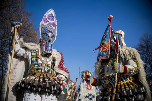 Dancers, known as “Kukeri”, perform on January 27, 2019 during the International Festival of the Masquerade Games in Pernik, near Sofia. The three-day festival, which started on January 25, has participants sporting multi-colored masks, covered with beads, ribbons and woolen tassels while the main dancer, ladened with bells to drive away sickness and evil spirits, sways like a wheat spikelet heavy with grain. (Photo by Nikolay Doychinov/AFP Photo)