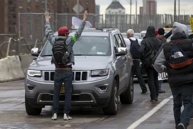 Demonstrators stop traffic on the Brooklyn Bridge during a protest against police brutality against minorities, in New York April 14, 2015. (Photo by Brendan McDermid/Reuters)