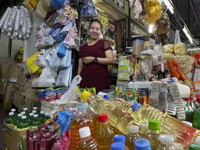 Charina Em poses in one of her food stores in Manila on Thursday, September 21, 2023. Food store owners in the capital city are losing money, with prices increasing rapidly since Sept. 1. “We cannot save money anymore. It is like we just work so that we can have food daily”, said Em. (Photo by Joeal Calupitan/AP Photo)