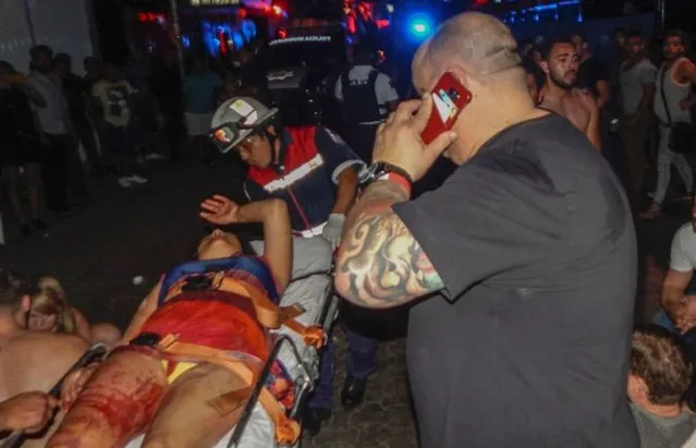 Paramedics attend an injured woman at the Blue Parrot nightclub in Playa del Carmen, Quintana Ro state, Mexico where 5 people were killed, three of them foreigners, during a music festival on January 16, 2017. (Photo by Victor Vargas/AFP Photo)