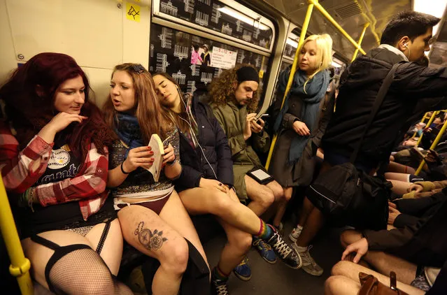 Participants of the No Pants Subway Ride ride a train on January 12, 2014 in Berlin, Germany. The annual event, in which participants board a subway car in January while not wearing any pants while behaving as though they do not know each other, began as a joke by the public prank group Improv Everywhere in New York City and has since spread around the world, with enthusiasts in around 60 cities and 29 countries across the globe, according to the organization's site. (Photo by Adam Berry/Getty Images)