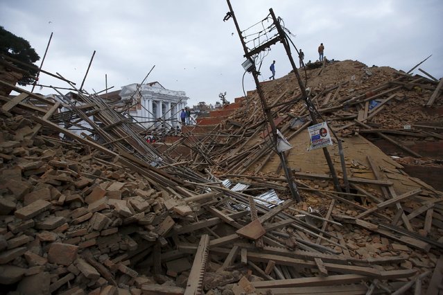 People work to rescue trapped people inside a temple in Bashantapur Durbar Square after an earthquake hit, in Kathmandu, Nepal April 25, 2015. (Photo by Navesh Chitrakar/Reuters)