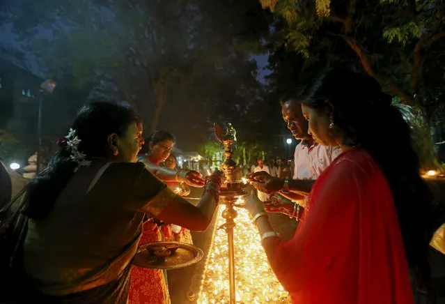 Sri Lankan Tamil devotees light oil lamps during the annual Maha Shivaratri festival at Shivam Kovil in Colombo March 7, 2016. (Photo by Dinuka Liyanawatte/Reuters)
