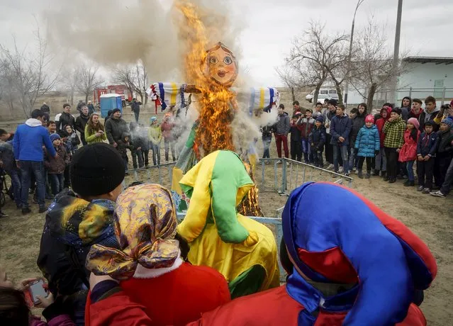 People burn an effigy of Lady Maslenitsa as they celebrate Maslenitsa, or Pancake Week, in Baikonur, Kazakhstan, March 13, 2016. (Photo by Shamil Zhumatov/Reuters)