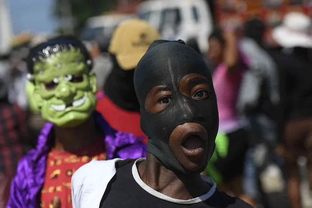 Supporters of the “G9 and Family” gang join the group's march through La Saline neighborhood in Port-au-Prince, Haiti, Friday, October 22, 2021. (Photo by Matias Delacroix/AP Photo)